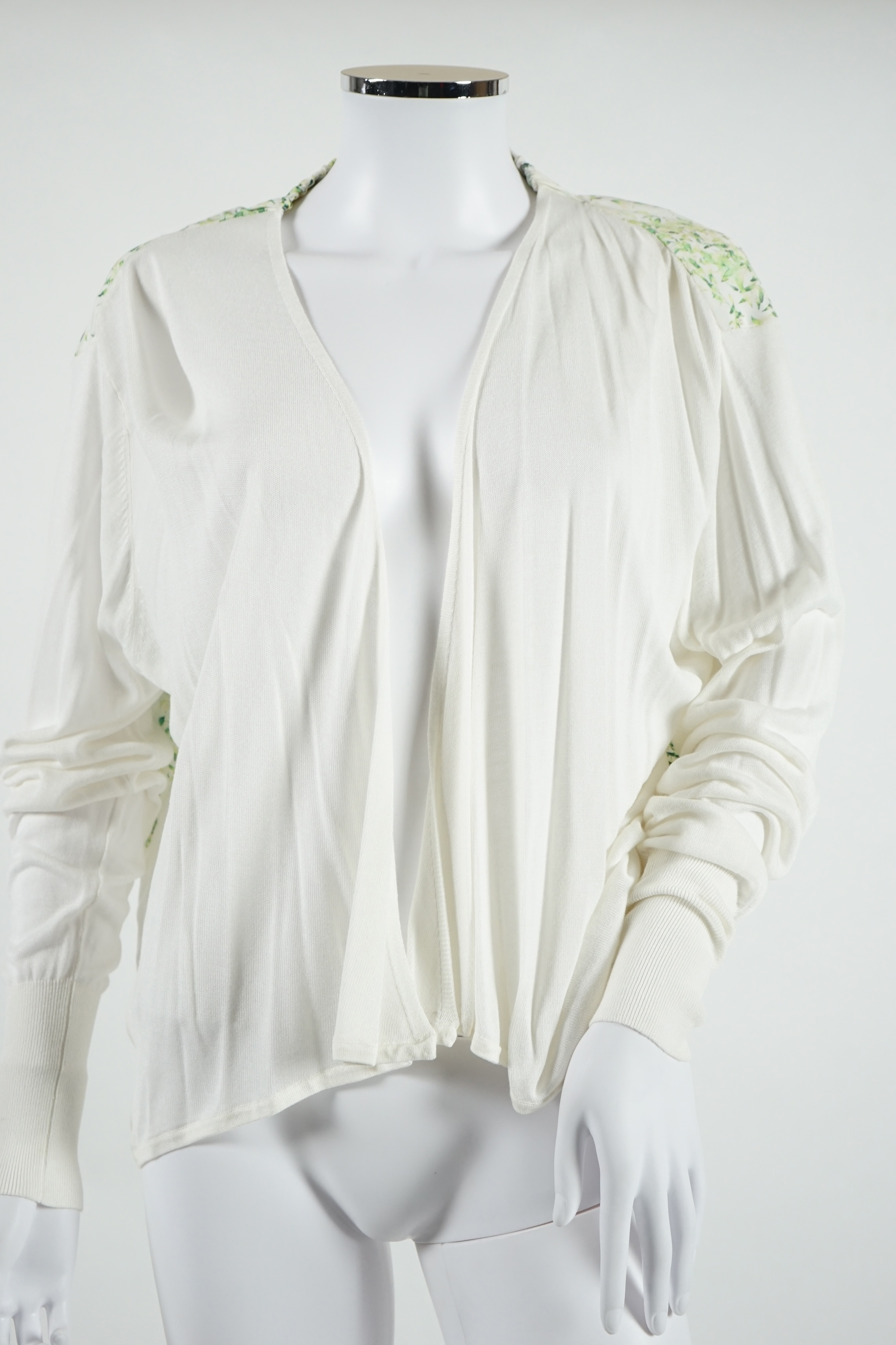 A lady's Angela Caputi silk cream skirt and blouse with fruit design size 46, a Ted Baker white lightweight cardigan with leaf design to the back size 4, a Rawhide dusky pink long laser cut coat size 14 and a Georgina vo